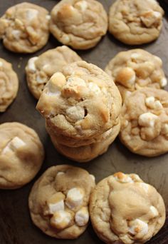 cookies with white chocolate chips are on a baking sheet