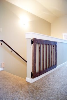 an empty room with a wooden railing on the floor