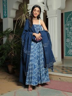 Farah smoked printed blue anarkali suit with pant and dupatta set is perfect for a festive season . Cotton cambric fabric makes it perfect for summer weather. Mirror work shell strap with gota detailing on the dupatta give the set a classic look. Product has lining. Pant has two side pockets, back elasted waistband. Cold wash and Dry clean only.Type of Work: Hand Block/ Solid Fit: Fitted at bust Model Height: 5'4 Measurements: Kurta- 52.25" Pants- 36.25" Dupatta- 95.75" SKU#: 11703066BL Disclaim Indigo Anarkali Set For Festive Diwali Occasion, Festive Indigo Anarkali Set With Dupatta, Indigo Salwar Kameez With Dupatta For Navratri, Navratri Indigo Salwar Kameez With Dupatta, Bohemian Blue Palazzo Set For Festivals, Blue Bohemian Palazzo Set For Festivals, Indigo Anarkali Dupatta For Eid, Festive Indigo Anarkali Set, Blue Bohemian Chanderi Palazzo Set