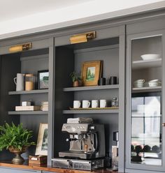 a coffee maker and some shelves in a room