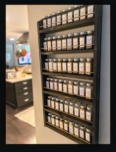 a wall mounted spice rack in a kitchen