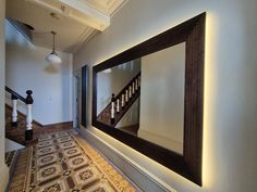 This extra-large wall mirror will suite either contemporary or traditional interior styles. The grand frame made in cherry and finished in dark oak stain oversized mirror is certainly a real showstopper. With engraved Greek key pattern, it gives this mirror an awe - inspiring finish. The rectangular frame dresses the wall, adding elegance and a sense of spaciousness Cleverly incorporated led lights add a warm and cosy glow to the frame and the hallway. Thick Framed Mirror, Hallway Mirror Entrance, Frame Large Mirror, Mirror Behind Nightstand, Oversized Wall Mirror, Extra Large Wall Mirrors, Mirror Stairs, Extra Large Mirrors, Oversized Wall Mirrors