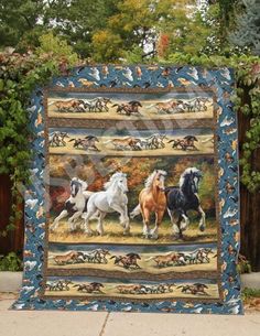 a quilt with horses running in the grass