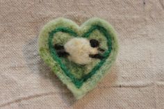 a small stuffed animal in the shape of a heart