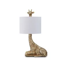 a gold giraffe lamp with a white shade on it's head and neck