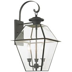 an outdoor light fixture with three lights on the front and back of it, against a white background