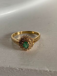 k18 gold ring 2.2 grams emerald gem stone 0.21 carat diamond around the gem stone is 0.17 carat size 10.5 This is a preloved ring. Been using it for a few years now. Indian Gold Stone Rings, Design Of Rings Gold, Indian Traditional Stone Rings, Year Rings Gold, Indian Rings Gold, Traditional Gold Ring, Green Stone Gold Ring, Green Stone Ring For Women, Gold Ring With Stone