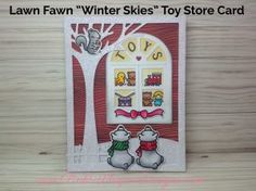 a card with two snowmen in front of a tree and the words lawnn'winter skies toy store card