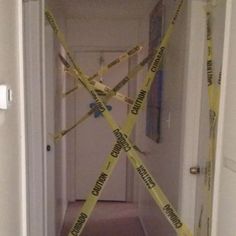 a hallway with yellow caution tape on the floor