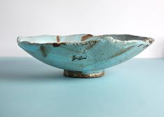 a blue bowl sitting on top of a table