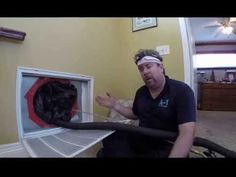 a man sitting on the floor in front of an open refrigerator