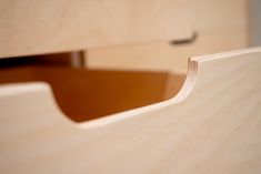 a close up view of a wooden drawer with drawers in the back ground and an open drawer on the right side