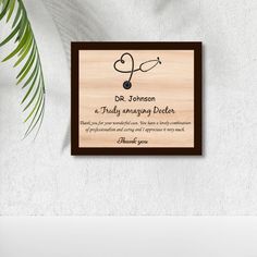 a wooden plaque with the words dr johnson on it and a plant next to it