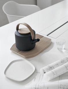 a tea pot sitting on top of a white table