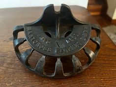 a metal object sitting on top of a wooden table