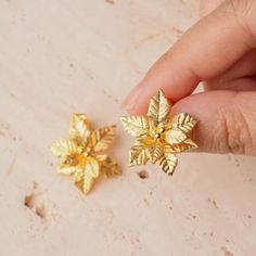 Get into the holiday spirit with our Joyful Poinsettia Stud Earrings, available in both warm gold-plated and sleek sterling silver. These earrings are inspired by the beloved poinsettia, the ultimate symbol of Christmas cheer and renewal. With their beautifully detailed petals and festive shine, they're the perfect little accessory to brighten up your holiday outfits or to give as a thoughtful gift. Whether you're going for the golden glow or the classic silver sparkle, these studs will add just Gold Flower-shaped Earrings For Festive Occasions, Elegant Gold Earrings For The Holiday Season, Elegant Gold Earrings For Holiday, Gold Holiday Earrings For Party, Gold Earrings For Party And Holiday, Gold Jewelry For Festive Holiday Occasions, Gold Jewelry With Matching Earrings For Holiday, Gold Holiday Party Earrings, Gold Flower Earrings For Festive Occasions