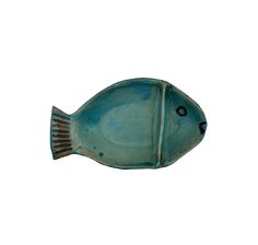 a blue ceramic fish on a white background