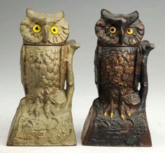 two owl figurines sitting next to each other