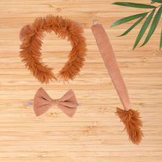 a wooden table topped with different types of hair and bow ties on top of it