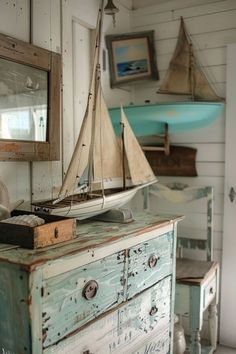 a sailboat is on top of an old dresser