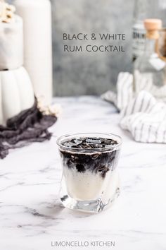 creamy white cocktail in an old fashioned glass with a layer of black on top White And Black Cocktail, Black And Gold Drinks, Black Liquor Drinks, Black And White Drinks Cocktails, Cow Themed Cocktails, Black Rum Cocktails, Black Themed Food, Black Drinks Cocktails, Black And White Party Food