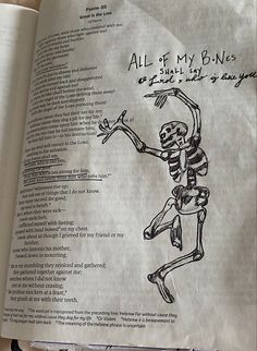 an open book with a drawing of a skeleton