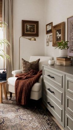 a living room filled with furniture and pictures on the wall