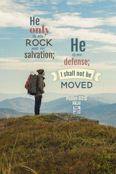 a man standing on top of a grass covered hill with a bible verse above him