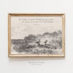 a framed photo with a quote on it in front of a white wall and an image of two deer