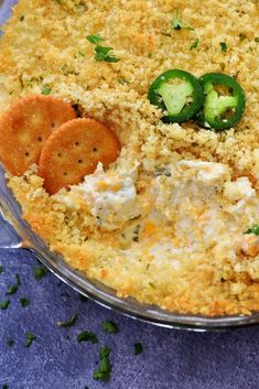 a casserole dish with crackers and vegetables in it