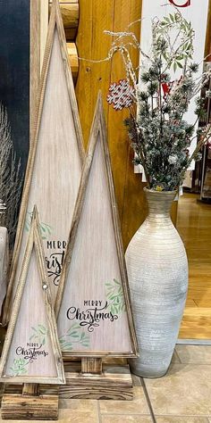 three wooden christmas trees sitting next to each other