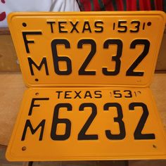 two yellow license plates sitting next to each other