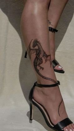 a woman's legs with tattoos on them