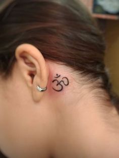 a woman with a small tattoo behind her ear