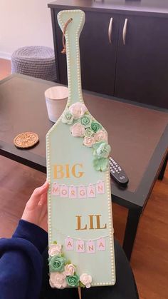 a cake shaped like a wine bottle with flowers on it and the words, big morgan lil