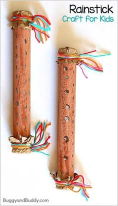 two wooden pegs with strings attached to them on a white background and text reading rainbowstick craft for kids