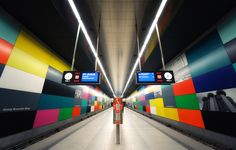 an empty subway station with multicolored walls