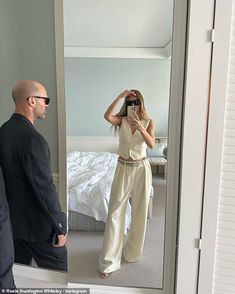 a man is taking a selfie in front of a mirror