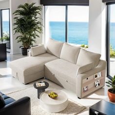 a living room filled with furniture next to a large window covered in windows overlooking the ocean