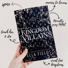 a hand holding up a book with the title kingdom villain's written on it