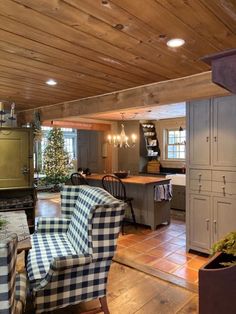 a living room filled with furniture next to a kitchen