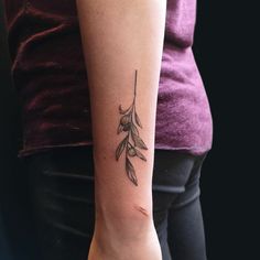 a woman's arm with a small tattoo on the left side of her arm