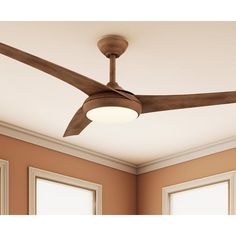 a ceiling fan in a room with two windows