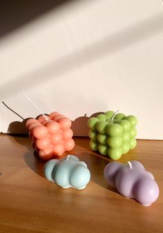 three candles sitting on top of a wooden table