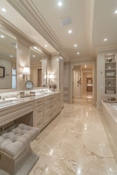 a large bathroom with marble floors and white walls, along with built in sinks and mirrors