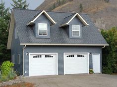 two garages are shown in front of a mountain