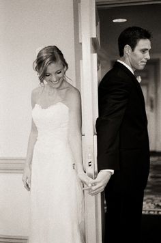 a bride and groom are standing in the doorway