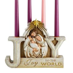 a nativity set with three candles and an image of the virgin mary holding a baby jesus