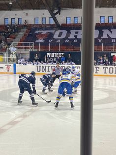 the hockey players are playing on the ice