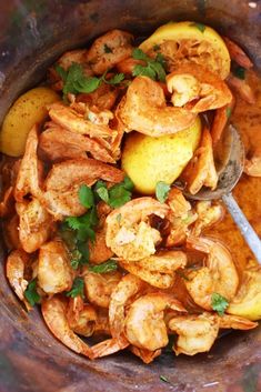 a bowl filled with cooked shrimp and potatoes